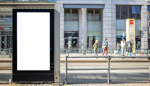 Empty billboard for public advertisement at the bus stop. Space for text. People and city background.