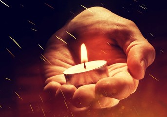 Burning candle in male hand,  religion concept