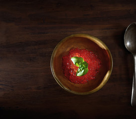 red caviar and a glass of vodka on a wooden background. top view. rustic style.