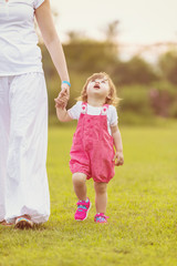Fototapeta premium mother and little daughter playing at backyard
