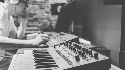 asian male composer making music in home studio