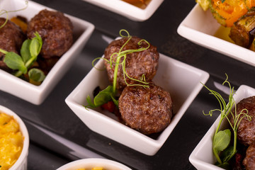 Hot quenelles with stewed vegetables and greens