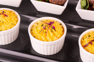 Potatoes puree baked in an oven with green onions and greens