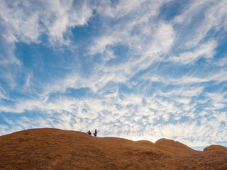 Man and woman standing on the top, enjoying the phenomenal view of Spitzkoppe in Namibia