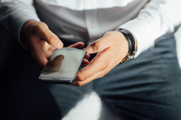 Mock up of a man holding device and touching screen. Clipping path