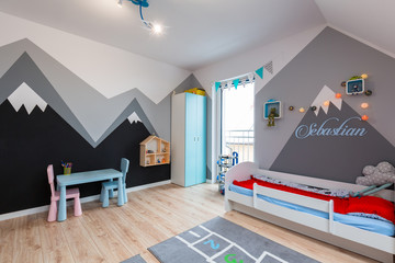 Modern bedroom for boy and girl with furnitures and toys