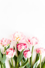 Pink tulips on white background. Minimal floral concept greeting card. Flat lay, top view.