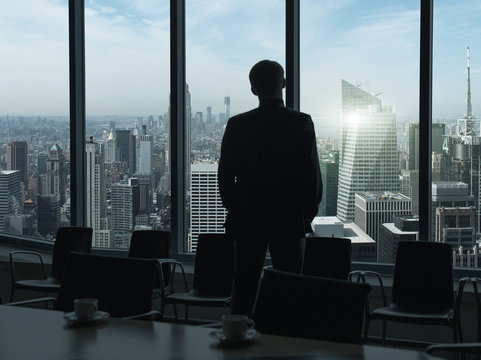 Side view of a businessman looking through window before meeting