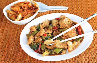 Sesame Chicken Stir Fry with side of Sweet and Sour Chicken on Bamboo Mat.