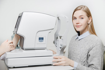 Young woman reception doctor ophthalmologist to check quality of eye vision.