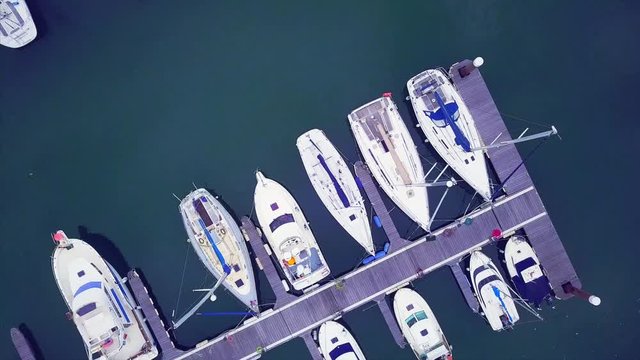 Yacht parking. Yacht and sailboat is moored at the quay, Aerial view of sailing yachts and boats near wooden piers.