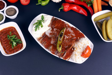 Turkish iskender kebab on dark background. Traditional flavors. Doner kebab made from beef and lamb. close up