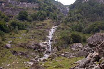 Water Fall and Small River in the Swiss Alps during Cloudy Day