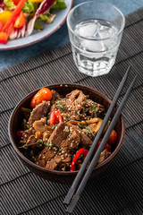 Soba noodles with beef, mushrooms, cherry tomato and sweet peppers. Asian cuisine