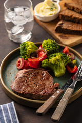 Grilled Beef steak with vegetables. Meat with grilled bell pepper, broccoli and onions