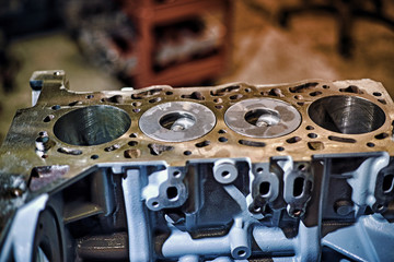 Automotive four-cylinder engine water cooling during repair.