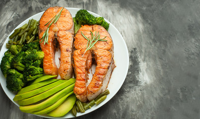 Grilled salmon steak grilled with vegetables. Delicious and healthy meal