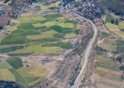 Aerial view of villages, farms, and river valley in rural Ethiopia.