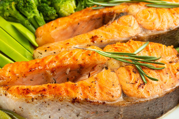 Grilled salmon steak grilled with vegetables. Delicious and healthy meal