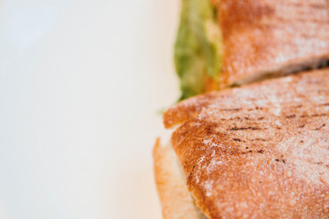 Fresh underwater sandwich with chicken, cheese, tomatoes, salad on a plate