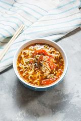 Fresh asian vegetable soup with noodles on concrete background