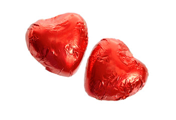 Red Foil wrapped chocolate hearts isolated on white background