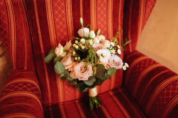 Wedding bridal bouquet on the chair. Beautiful fresh flowers. Wedding decorations.