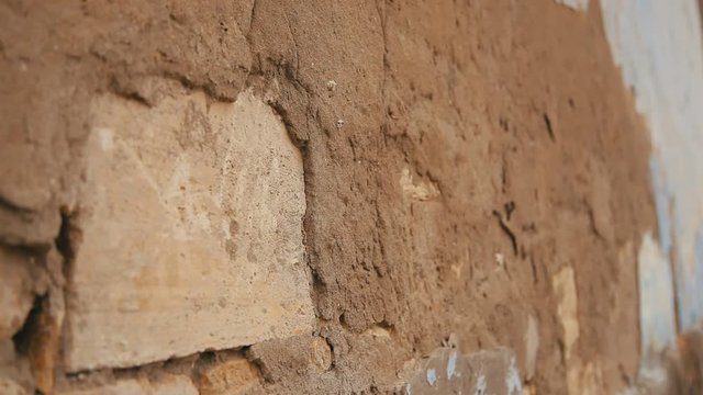 refocus on broken wall of the old house, close up