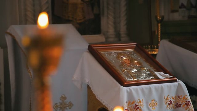 Kiev, Ukraine - November 13, 2018: refocus from candle stand to icon of Mother of God in the orthodox church