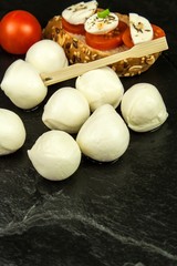 Mozzarella and tomatoes on slate plate. Diet food. Food preparation. Sale of cheeses. Protein diet.