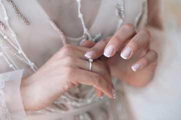 bride touches the engagement ring