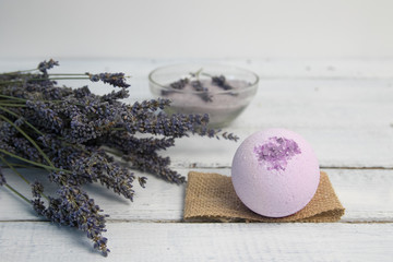 Natural cosmetics. Handmade lavender bath bombs and lavender flowers on white wooden planks