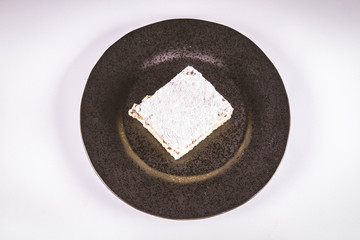 Napoleonka cake - a Polish type of cream pie - sprinkled with powdered sugar