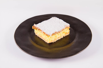 Napoleonka cake - a Polish type of cream pie - sprinkled with powdered sugar