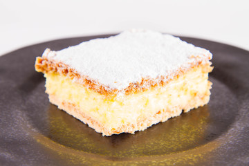 Napoleonka cake - a Polish type of cream pie - sprinkled with powdered sugar