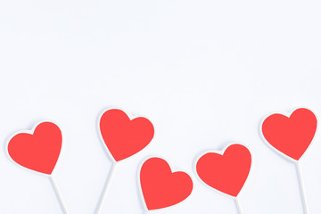 Group of vintage heart shaped chalkboards or signbaords living coral color with copy space in wooden frame isolated on white background, flat lay