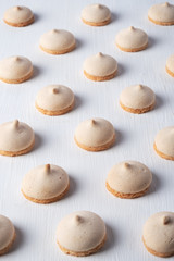 French meringue cookies on white wooden background