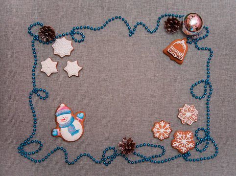 charming atmospheric christmas background with cones and celebratory biscuits in the form of snowflakes, bells and snowmen as a symbol of the new year 2019 (greeting card, greetings - concept)