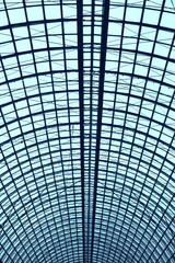 Modern building with curving roof and glass steel column.