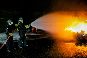 Firefighters training for fire fighting.