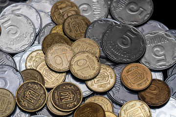 Ukrainian coins isolated on black background. Close-up view. Coins are located in the center of frame. A conceptual image.