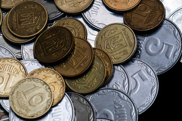 Ukrainian coins isolated on black background. Close-up view. Coins are located in the center of frame. A conceptual image.