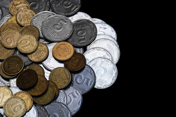 Ukrainian coins isolated on black background. Close-up view. Coins are located at the left side of frame. A conceptual image.
