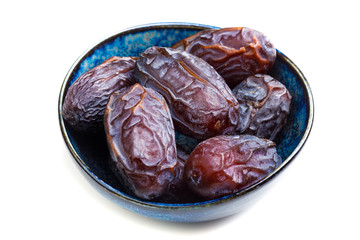 big dates in cup close-up, isolated on white background