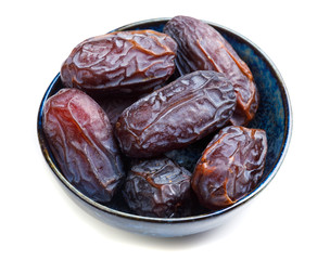 big dates in cup close-up, isolated on white background