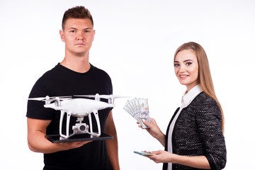 A man is holding a flying drone. On a white background. Theme selling and buying drone