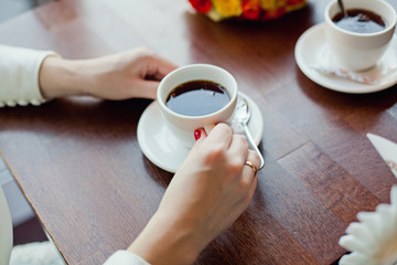 hands holding cup of coffee