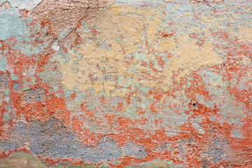 Old shabby orange paint on the wall.