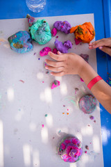 kid hands Playing with Colorful Clay