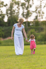 Fototapeta premium mother and little daughter playing at backyard